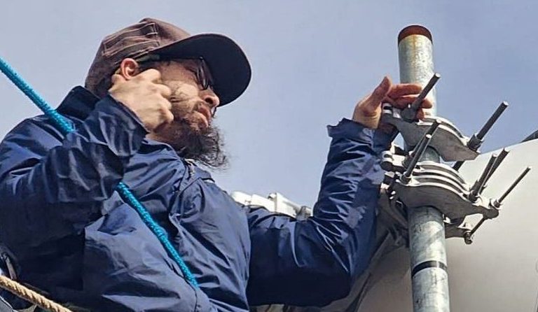 A surfnet employee installing a dish