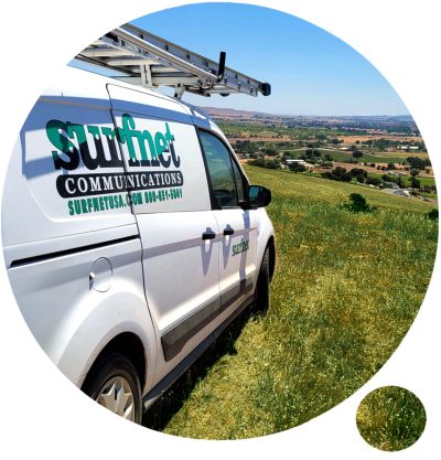 circle-about A Surfnet van with a ladder, overlooking a valley